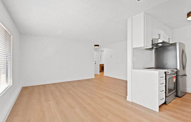 A kitchen with a stove top oven and a refrigerator.