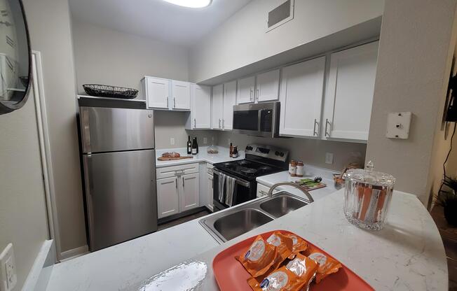 a kitchen with a sink and a mirror