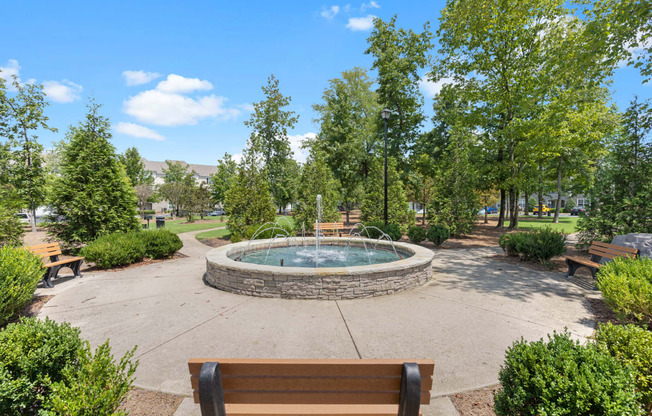 a park with a fountain and benches