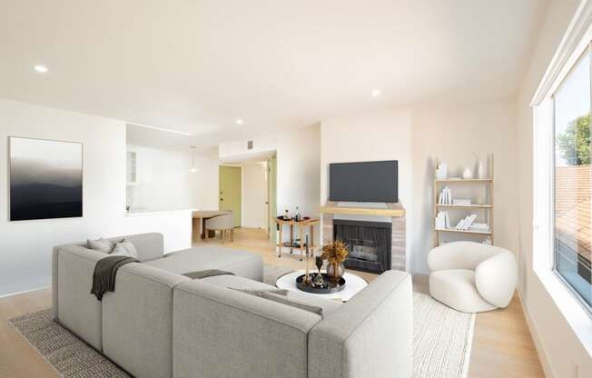 a living room with a gray couch and a fireplace