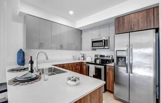 a kitchen with stainless steel appliances and a white counter top