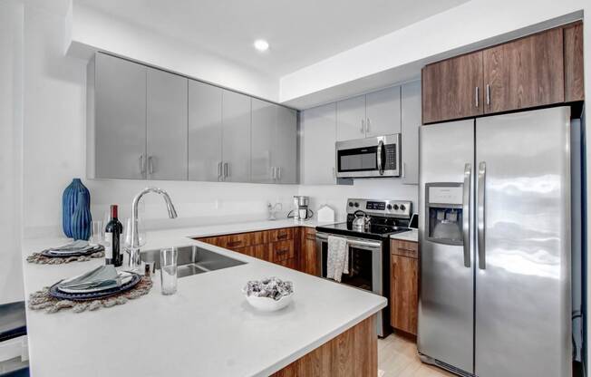 a kitchen with stainless steel appliances and a white counter top