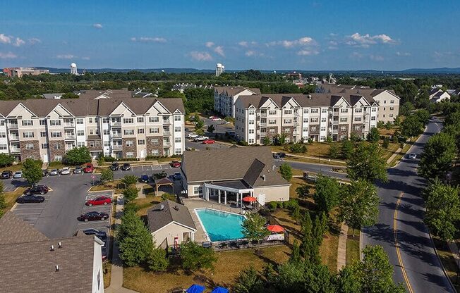 an aerial view of an apartment complex with a swimming pool