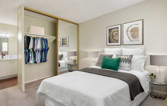 Bedroom with a mirrored closet doors, carpeted floors
