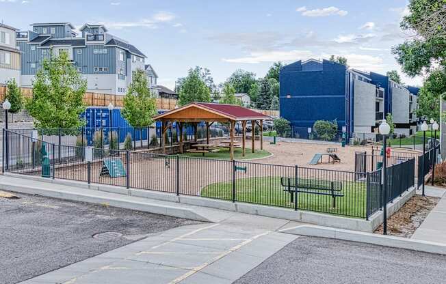 a park with a playground and a fence
