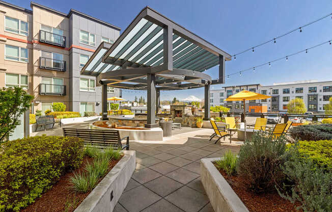 A patio with a table and chairs under a roof.