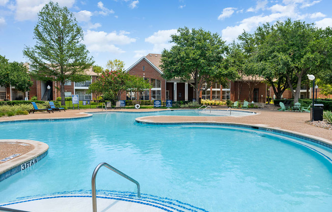 a large swimming pool with a building in the background