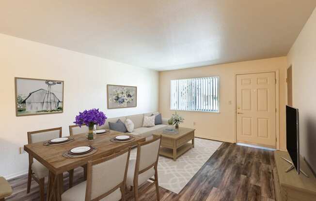 an open living room and dining room with a table and chairs
