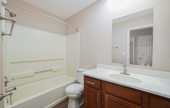 a bathroom with a sink toilet and bath tub