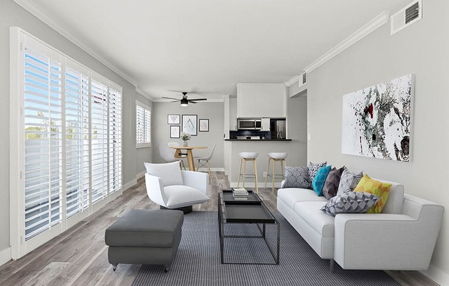 Living room with hardwood floor and large windows for natural light.