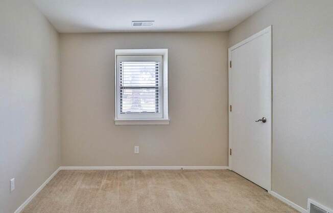 A room with a window and a door.