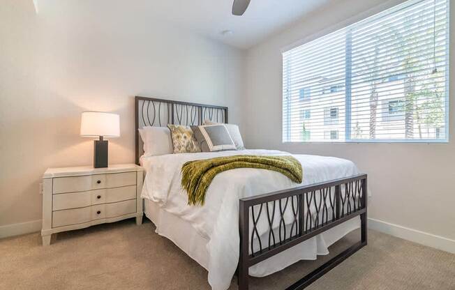 Bedroom with cozy bed  at Montecito Apartments at Carlsbad, California