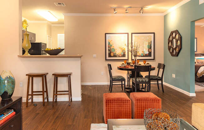 a living and dining room area with a table and chairs