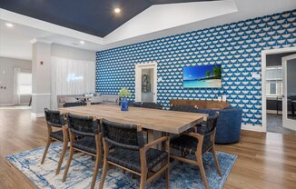 a dining room with a wooden table and chairs
