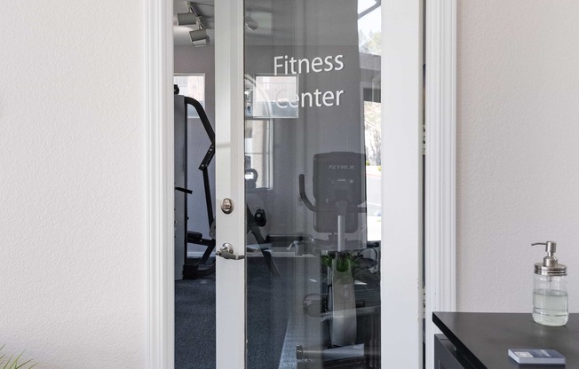 a glass door with a fitness center sign on it