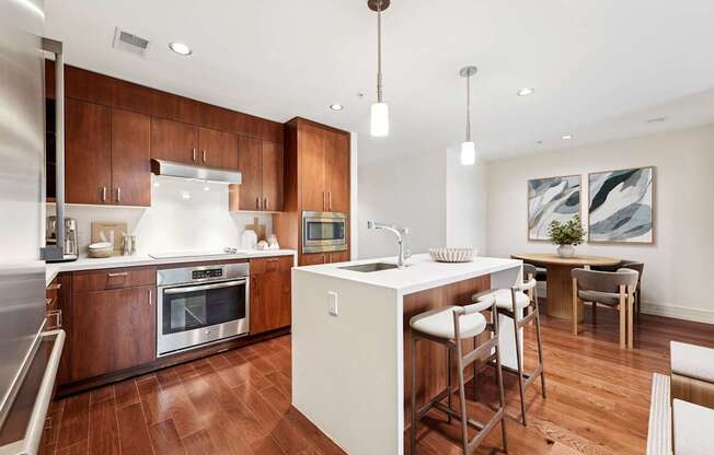 A modern kitchen with wooden cabinets and a white island.