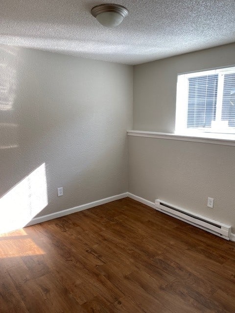 an empty room with a wooden floor and a window