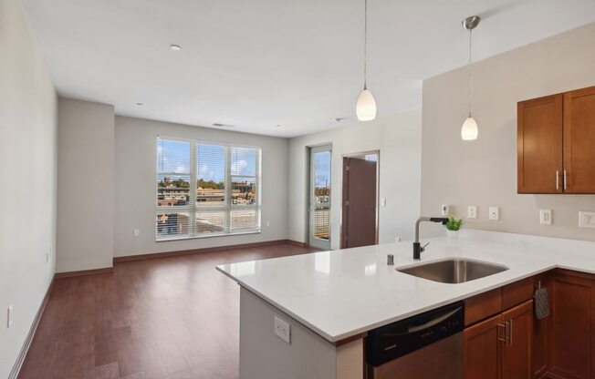 a large kitchen with a sink and a large window