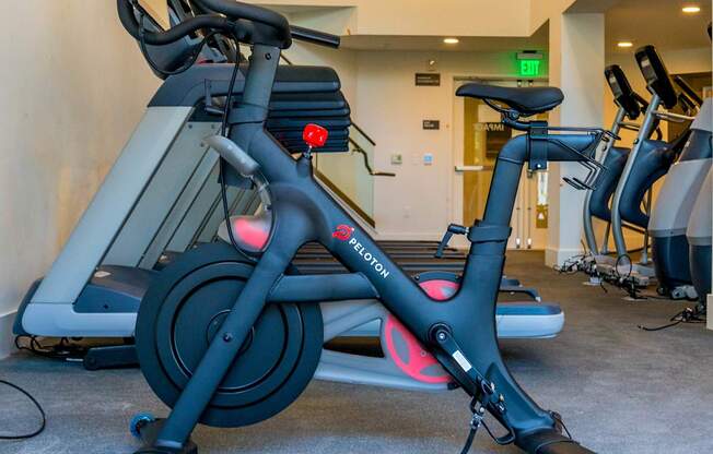 A stationary bike with a red light on the front wheel.