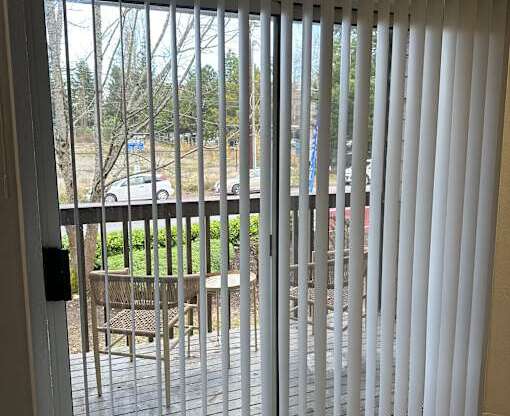 A white sliding door with a black handle.