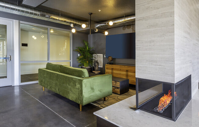 a green couch in a modern lounge area at Lotus Republic Apartments for rent in Downtown Salt Lake City, Utah