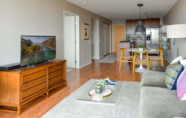 A living room with a grey sofa and a wooden cabinet.