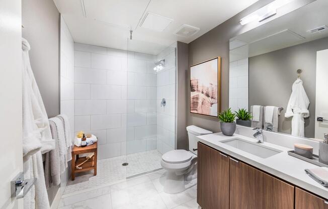 Frameless glass shower with tile surround and sleek fixtures.