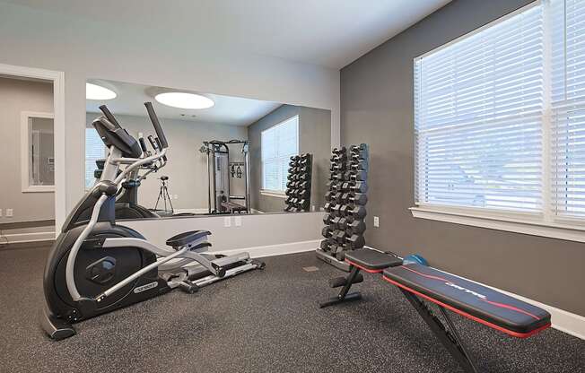A kitchen with black cabinets and a black refrigerator.