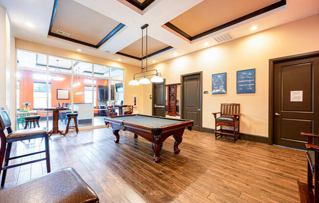 a game room with a pool table and a bar