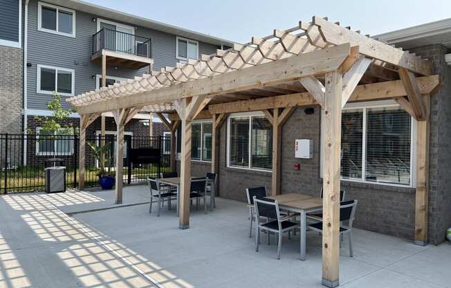 Outdoor kitchen area with barbecue and dining table.