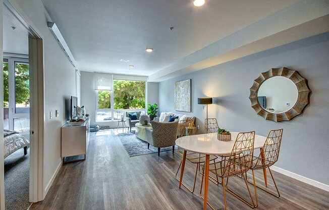 A modern living room with a white table and chairs. at Ravello Apartments, Redmond, WA, 98052