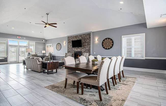 A modern clubhouse dining room with a wooden table and chairs at The Reserve at The Reserve at Destination Pointe in Grimes, IA 50111