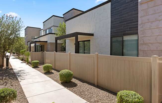 a wooden fence in front of a row of houses