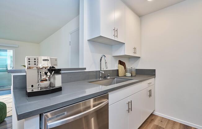 a kitchen with a sink and a refrigerator