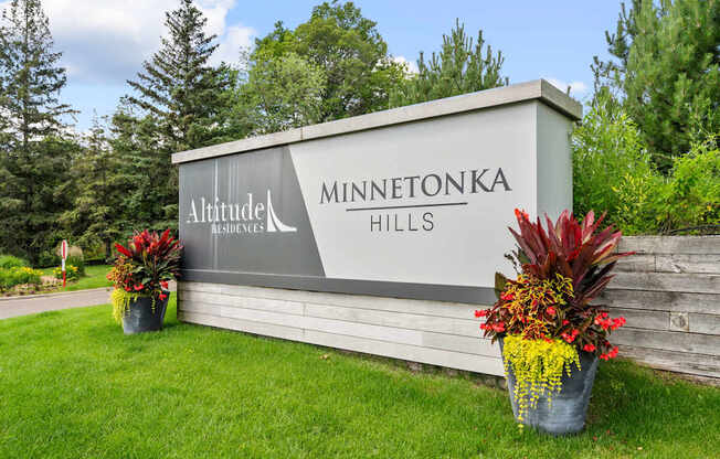 a sign hills at the entrance of a park with flowers