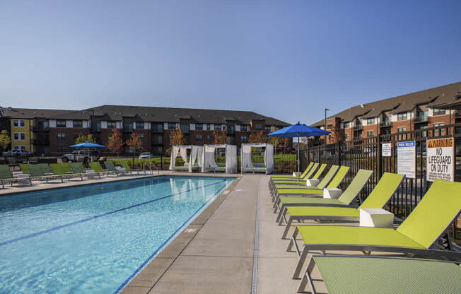 Outdoor swimming pool with cabanas and lounge chairs at Ascend at Woodbury MN 55129 new luxury apartments