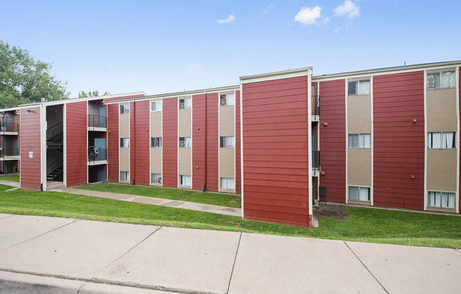 Brick exterior of Sunridge Apartment Homes in Englewood, CO, with on-site parking and easy access to South Broadway and downtown Denver.