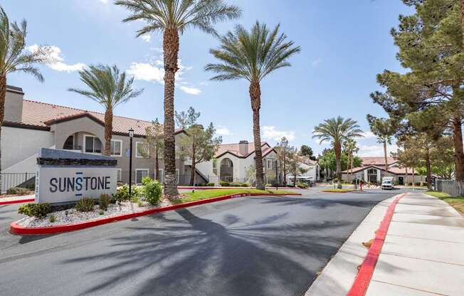 A street view of Sunstone residential area with palm trees lining the road.