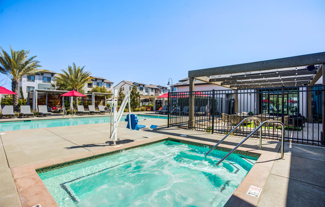 A pool with a slide and a building in the background.