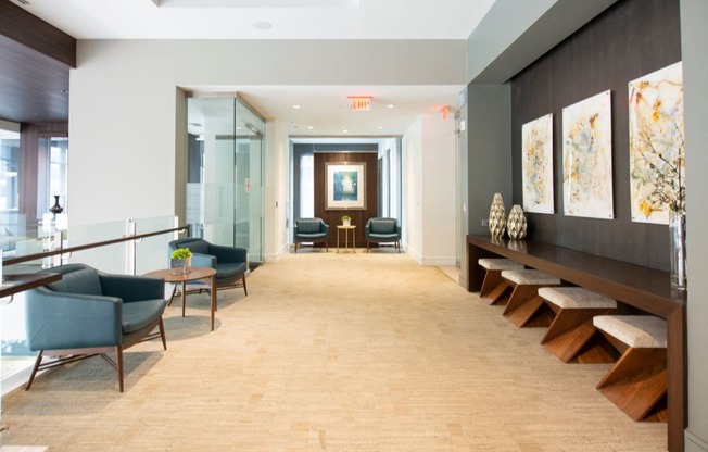 Arabelle Perimeter Luxury Apartments in Atlanta, GA 30328 photo of hallway with chairs and artwork