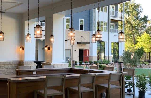 Outdoor bar seating area behind the clubhouse