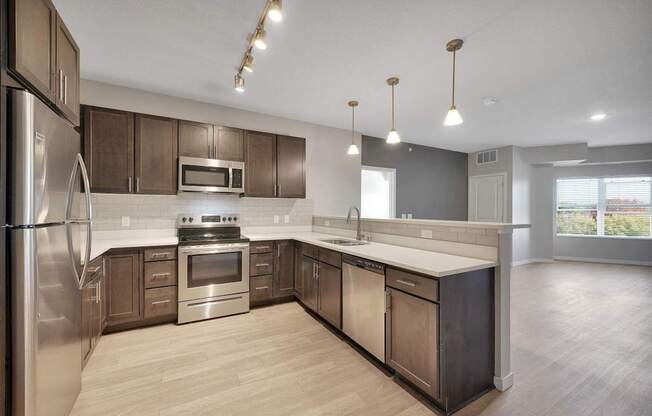 A modern kitchen with stainless steel appliances and wooden cabinets.