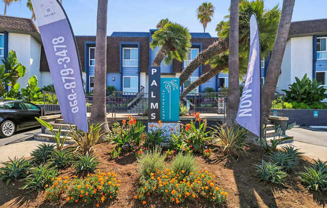 A garden with a sign that says Palms.