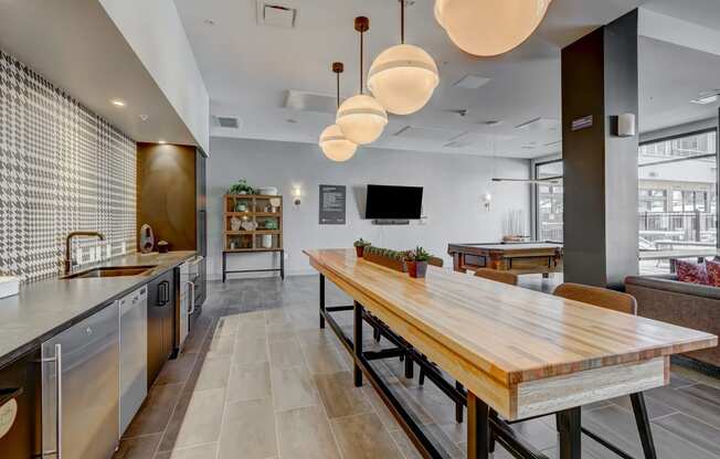 a kitchen and dining area with a wooden table and chairs