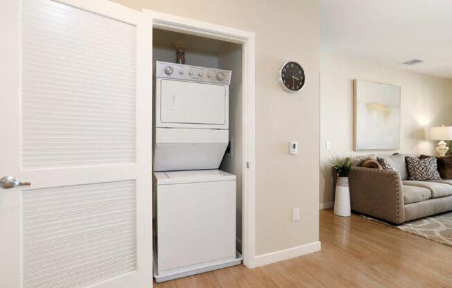 a white washer and dryer in a room with a couch