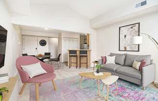 A living room with a high ceiling and a grey couch at Indian Lakes Apartments, Indiana, 46545