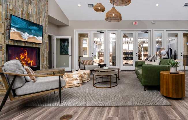 A living room with a fireplace and a painting of a beach scene on the wall.