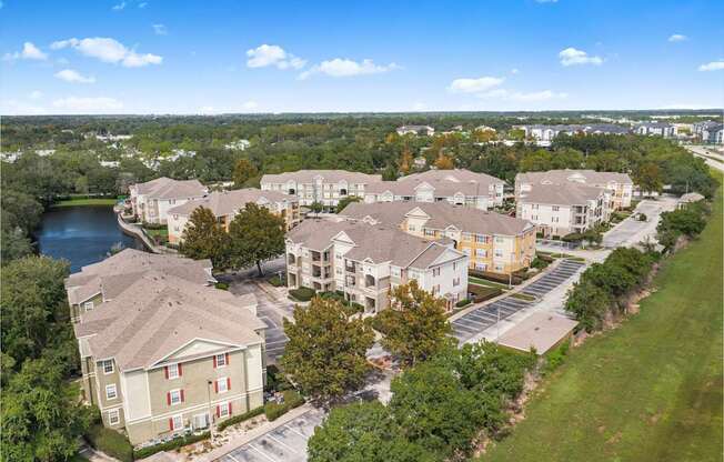 A large building complex with a parking lot in front.
