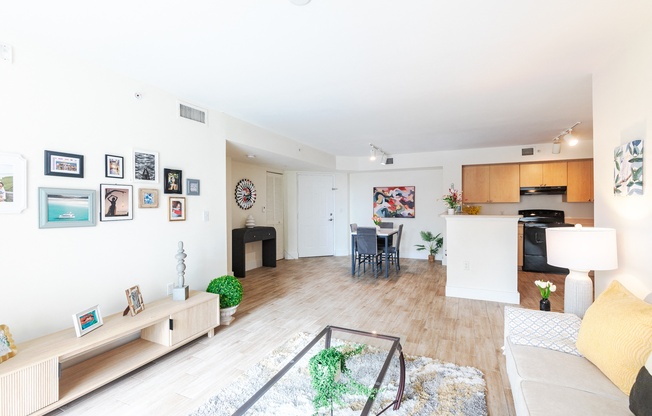 a living room with a couch and a table and a kitchen