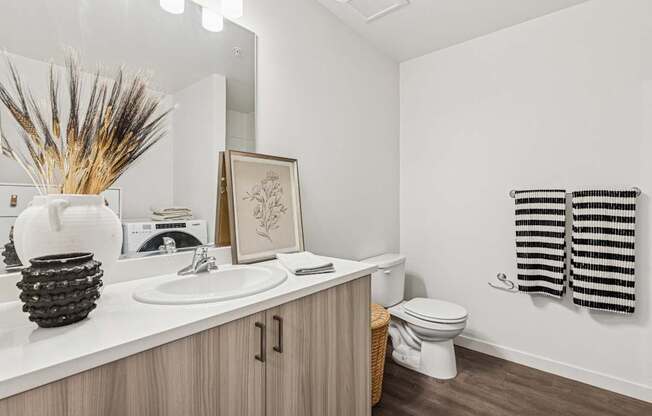 A bathroom with a white sink and toilet.